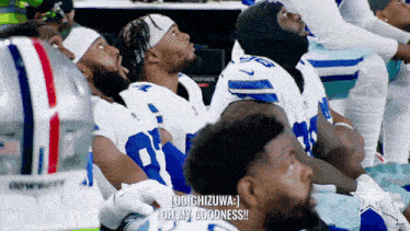 a group of cowboys players are sitting in the stands and one of them says " oh my goodness "
