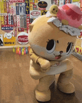 a squirrel mascot is standing in front of a coca cola advertisement