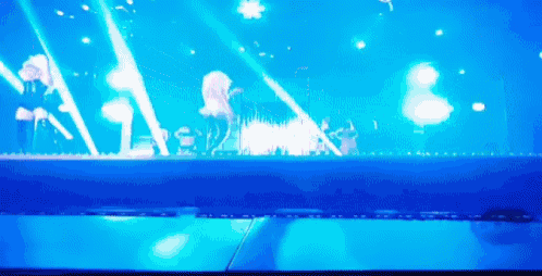 a blurry picture of a stage with a lot of blue lights