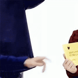 a person holding a piece of paper that says " i love you "