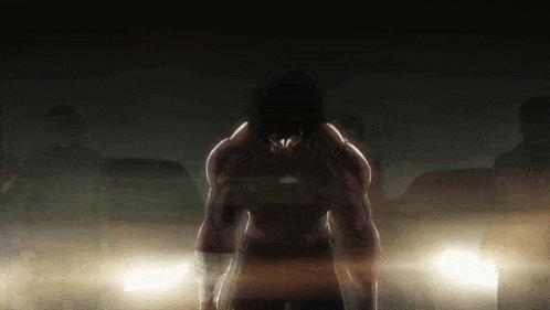 a man is standing in front of a group of cars in a dark room