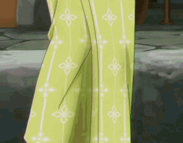 a person wearing a yellow shirt with white flowers and stripes