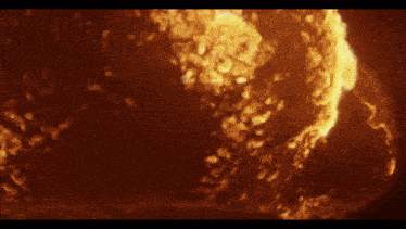 a close up of a fire with spanish written in the corner