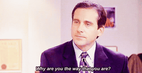 a man in a suit and tie is talking to a woman and asking her why are you the way that you are .