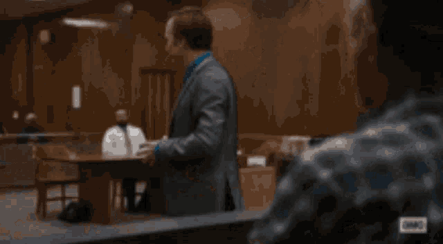 a woman in a judge 's robe is sitting at a desk with her mouth open
