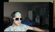 a person wearing headphones and sunglasses is sitting in a living room