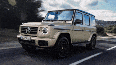 a mercedes driving down a road with a license plate that says sg 5016