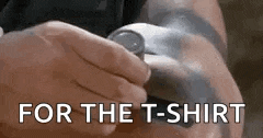 a person is holding a watch in their hand and the words `` for the t-shirt '' are written on the screen .