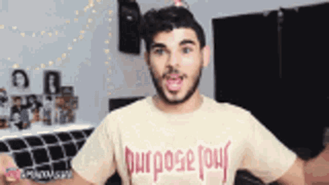 a man wearing a t-shirt that says " purpose " on it