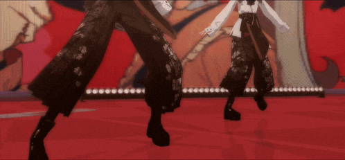 a couple of people standing on a stage with a red background