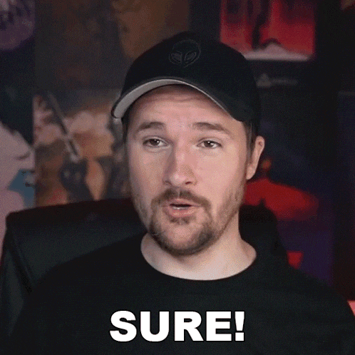 a man with a beard is wearing a hat and a black shirt and says sure !