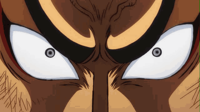 a close up of a cartoon character 's eyes with a black circle in the middle