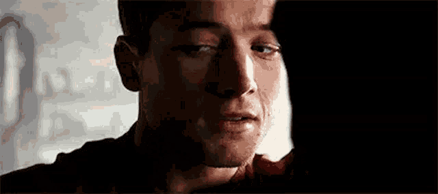 a close up of a man 's face with tears running down his cheeks .