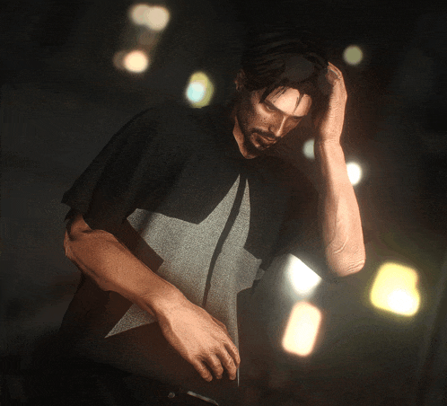 a man in a black shirt with a star on it holds his hand to his head