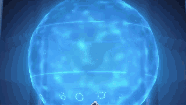 a blue sphere with bubbles coming out of it and a person standing in front of it