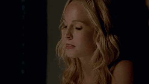a close up of a woman 's face in the dark .
