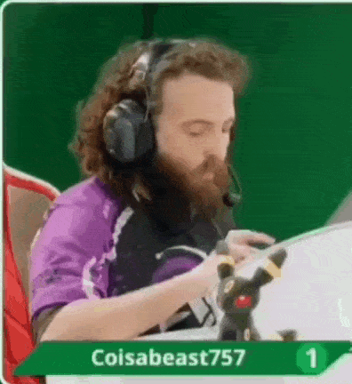 a man with a beard and headphones is playing a video game .