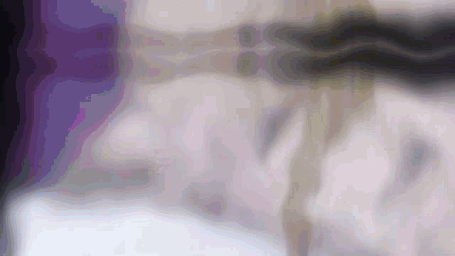 a blurred image of a person 's face with a purple background