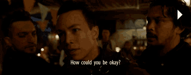 a man is talking to another man with the words how could you be okay below him