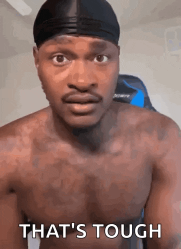 a shirtless man with a headband on his head is making a funny face .