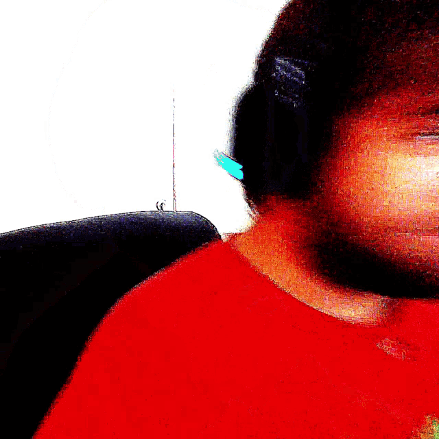 a blurry picture of a person with a red shirt on