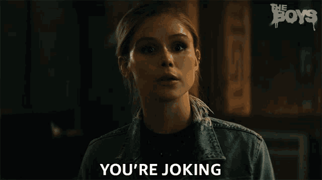 a woman in a denim jacket says " you 're joking " in a dark room