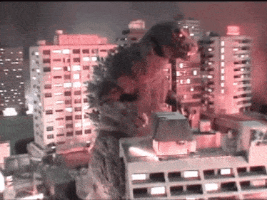 a giant monster is standing on top of a building with a sign that says ' tokyo '
