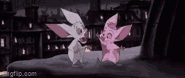 two cartoon animals are standing next to each other in front of a building at night .