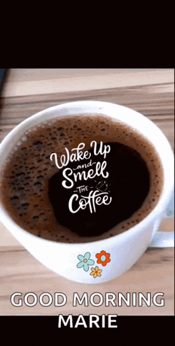 a cup of coffee with the words wake up and smell the coffee written on it