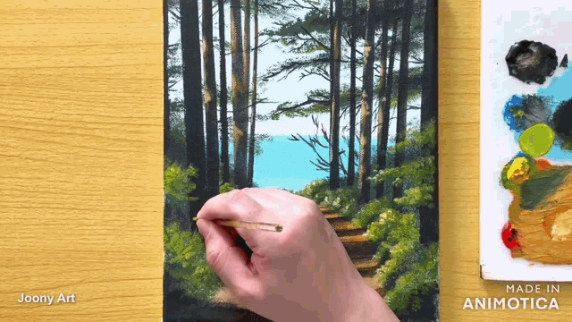 a person is painting a forest with the words made in animatica on the bottom right