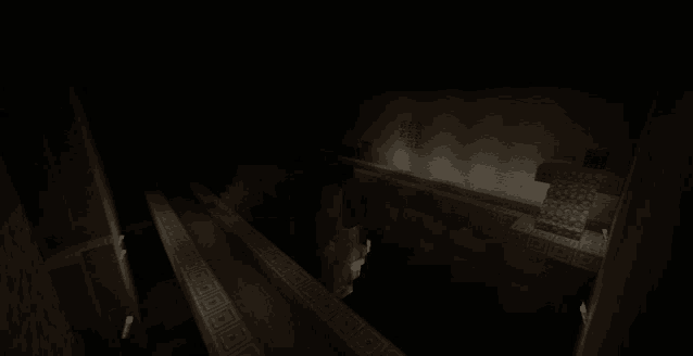 a dark room with a greek pattern on the wall