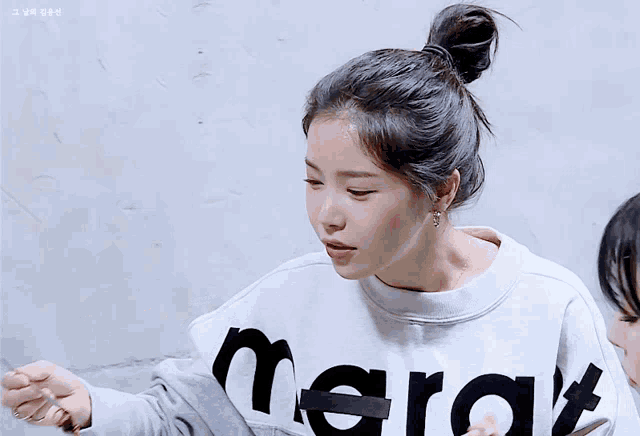 a woman wearing a white sweater with the word mar on it
