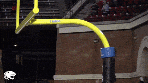 a basketball hoop with a yellow pole that says hoops on it