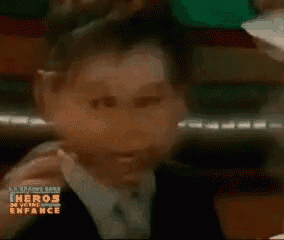 a cartoon character in a suit and tie making a funny face .