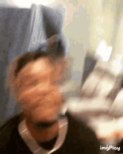 a blurry picture of a person 's face with the words imgplay written below it