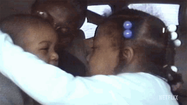 a woman is holding a child in her arms .