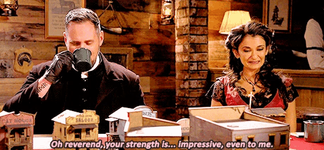 a man drinking a cup of coffee next to a woman who says " oh reverend your strength is ... impressive even to me "