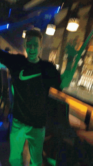 a man wearing a black nike shirt is dancing