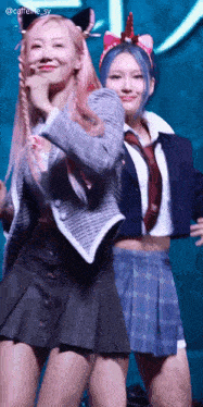 a couple of girls are standing next to each other on a stage .
