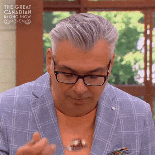 a man is on the great canadian baking show eating a cake