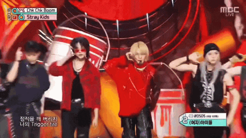 a group of young men are dancing on a stage with a sign that says mbc live on it