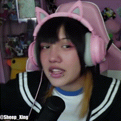 a girl wearing pink headphones and a cat ear headband .
