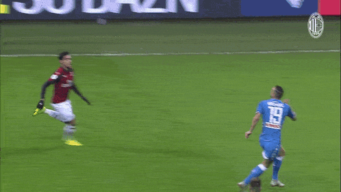 a soccer ball is going towards a goal with a banner behind it that says ac milan