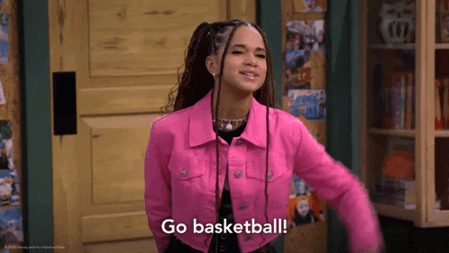 a woman in a pink jacket says " go basketball "