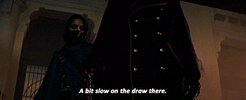 a man and a woman are standing next to each other and the woman says " a bit slow on the draw there . "