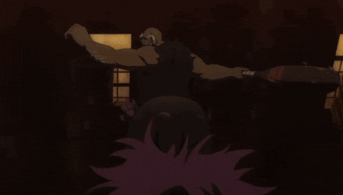 a man in a black cape is standing in a dark room .