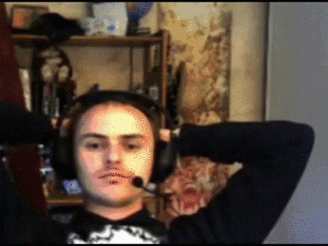 a man wearing headphones and a microphone is looking at the camera
