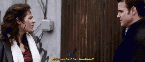 a man and a woman are talking to each other and the man is asking the woman if she touched her boobs .
