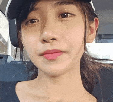 a close up of a woman 's face wearing a hat