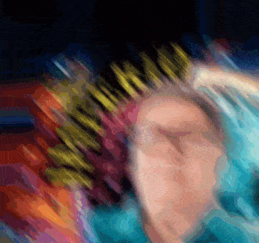 a blurry picture of a person holding a crown